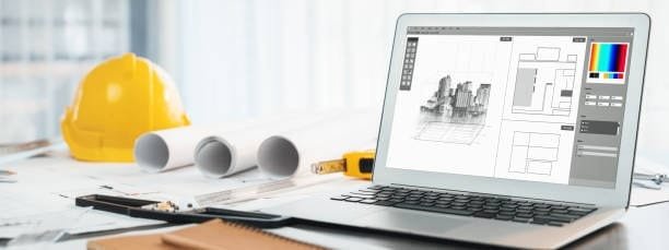 Laptop displaying architectural blueprints in CAD software on a desk with construction tools and a yellow hard hat, symbolizing digital design in architecture and engineering.