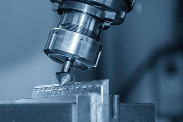 Close-up of a CNC milling machine cutting metal with a precision tool, focusing on the detailed machining process.