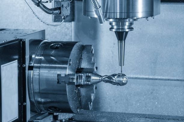 Close-up of precision milling machine cutting and shaping a metal part in a CNC machine with fine details.