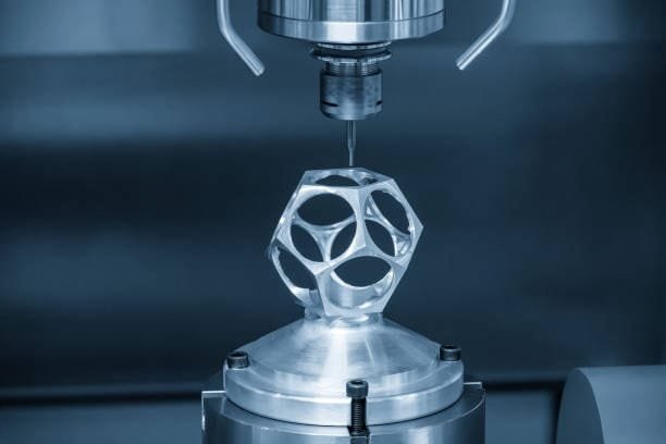Close-up of a CNC machine working on a complex 3D-printed metal object, showcasing intricate details and precision cutting.