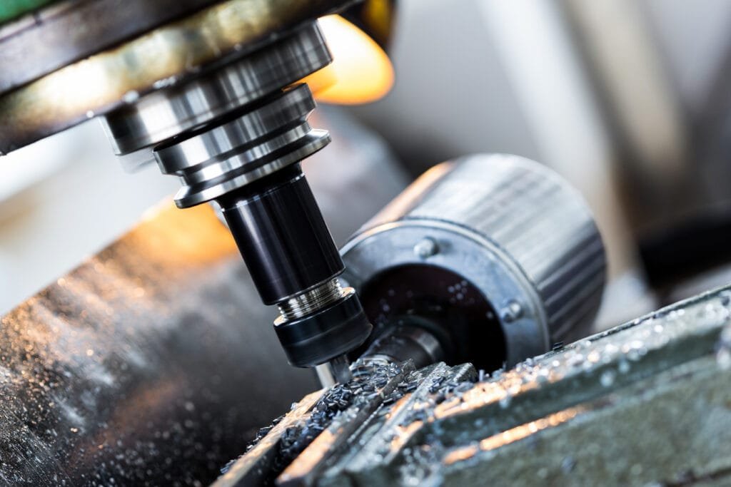 Close-up of CNC spindle cutting aerospace-grade metal with precision.