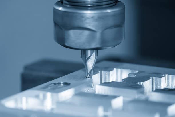 Close-up view of a CNC milling cutter precisely machining a metal workpiece.