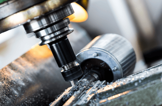 Close-up of CNC milling machine cutting aerospace-grade material.