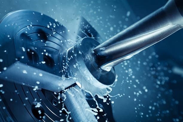 CNC milling process with coolant spray for precision cutting.