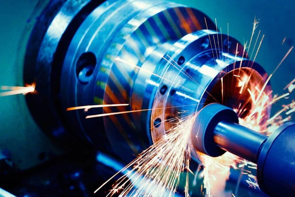 Close-up of a CNC machine grinding a metal workpiece with sparks flying during the machining process.