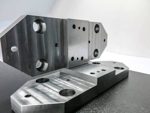 Custom CNC machined metal plates showcasing detailed drilling and low volume production quality.