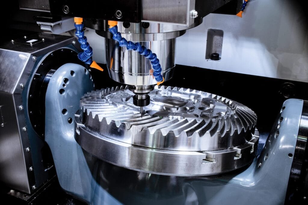 CNC machine fabricating a large precision turbine gear for aerospace applications.