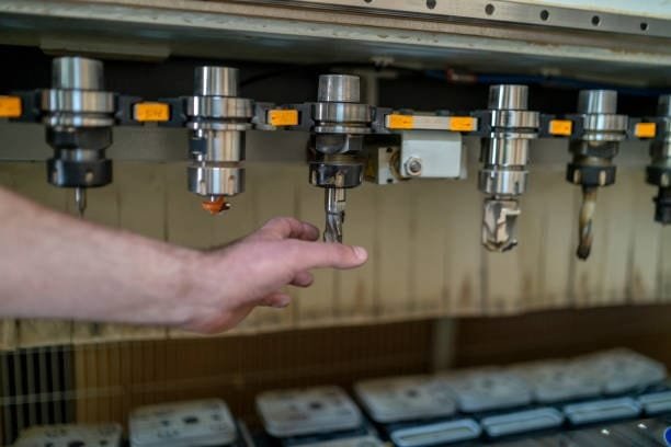 Hand selecting turning tools for CNC machining operations.
