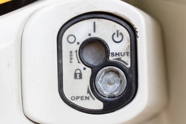 Close-up of a locking control dial fixture with open and shut settings for mechanical system safety