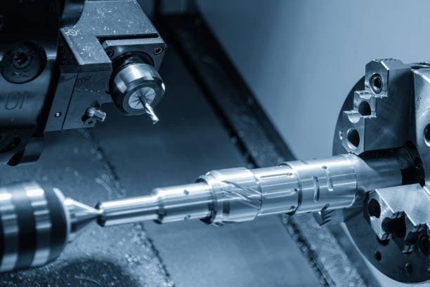 Precision CNC drilling operation on a rotating metal workpiece in a machining center.