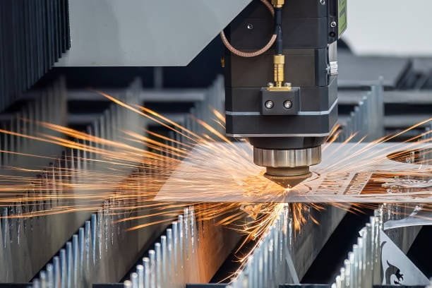 CNC laser cutting machine slicing through a metal sheet with precision.