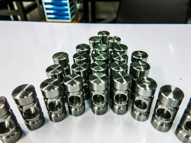Neatly arranged CNC machined components showcasing precision tolerances for metal parts.