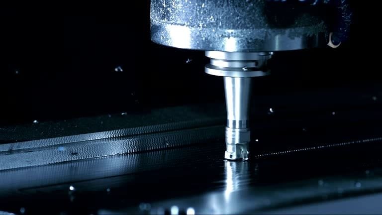 CNC turning operation on a metal rod, showcasing advanced technology for custom parts production.