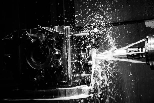 CNC machining operation at A-1 Machining using coolant spray for custom part production