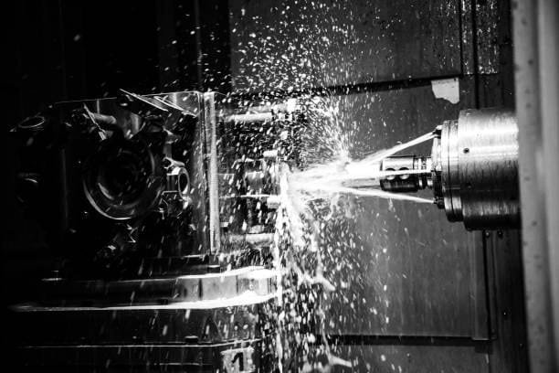 Close-up of coolant spray during CNC machining for precision custom components