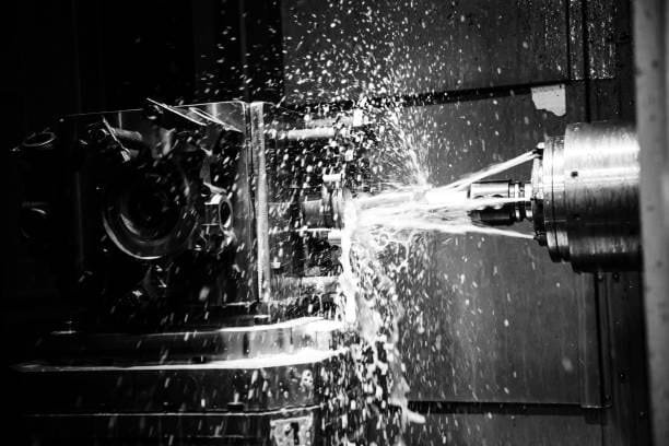 Coolant spraying during CNC machining of a custom metal part at A-1 Machining