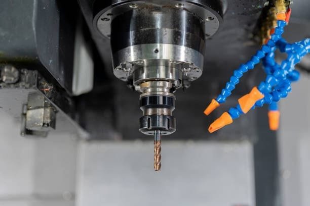 Cutting fluid nozzles positioned for efficient lubrication in CNC machines.