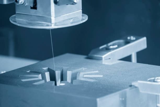 High-precision wire EDM cutting complex shapes in a metal part.