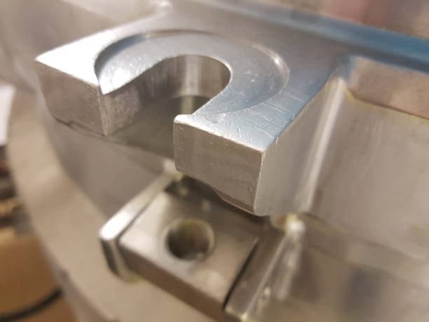 Close-up of a machined metal part featuring precision cutting and tight machining tolerances.