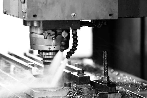CNC milling machine performing precision machining with coolant application at A-1 Machining