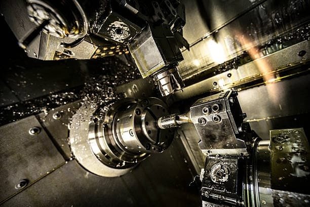 Multi-axis CNC milling machine performing complex metal cutting operations.