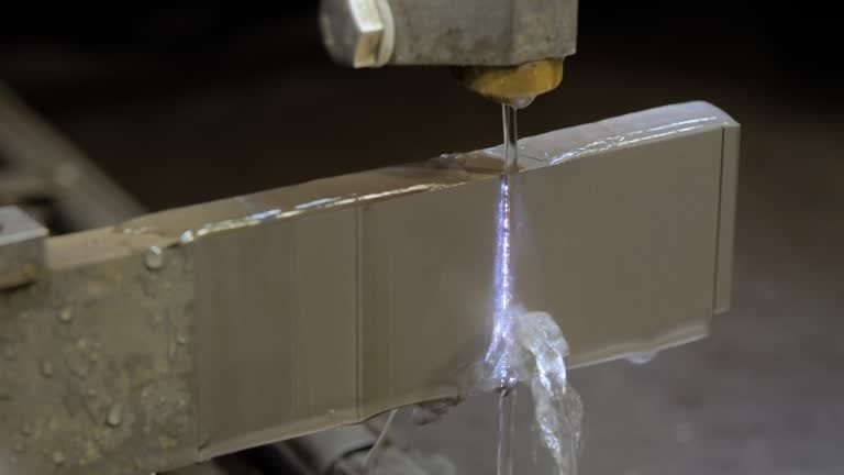 Close-up of wire EDM machine cutting through metal with electric discharge.