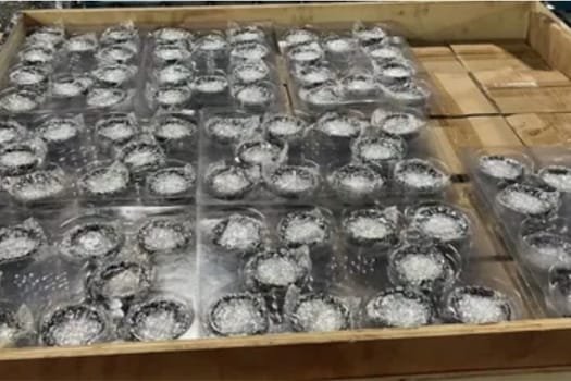 Packaged CNC-machined metal parts arranged in trays for low-volume production