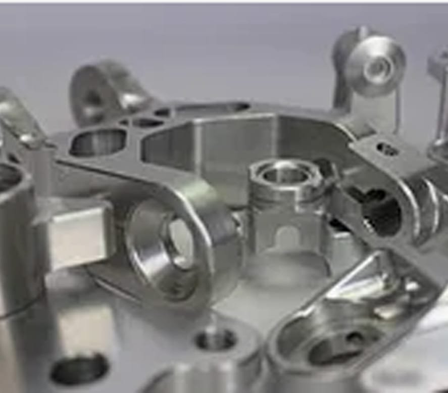 A collection of CNC-machined aluminum prototype parts featuring intricate features and precise finishes