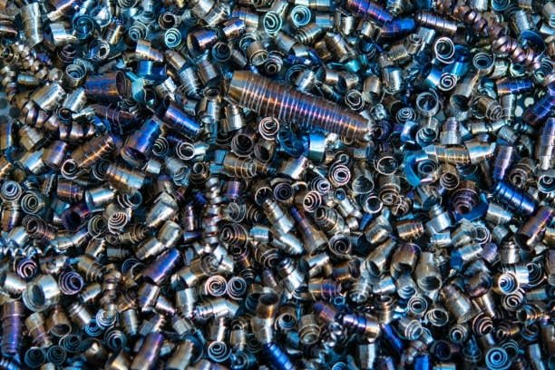 Colorized titanium turnings produced during CNC machining, reflecting material hardness