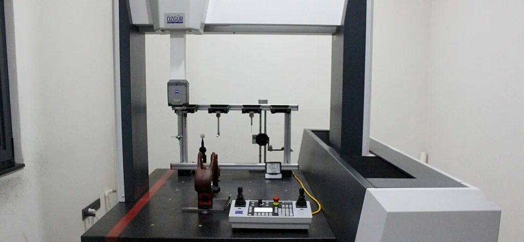 Coordinate Measuring Machine (CMM) inspecting a machined part on its table