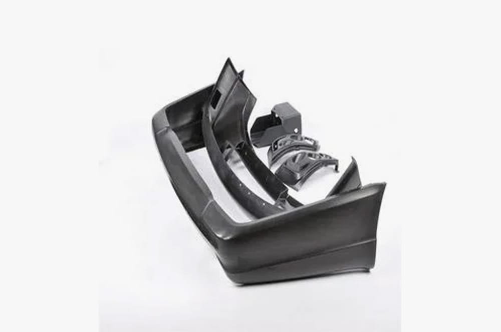 Set of black RIM-produced automotive body panels and bumper components