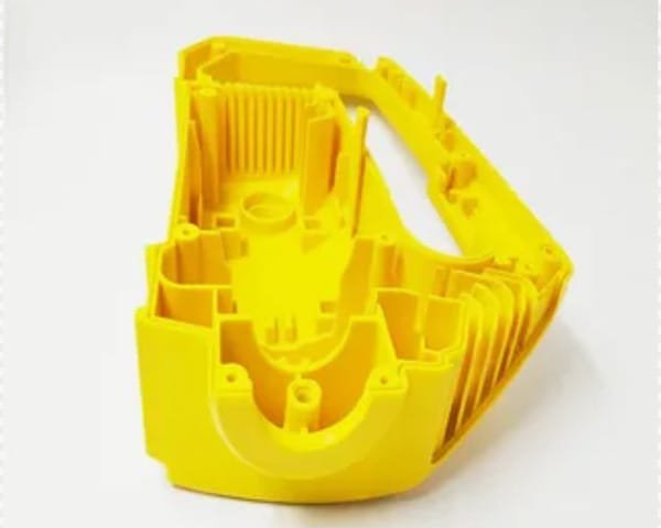 Yellow reaction injection molded plastic housing with complex rib and boss features