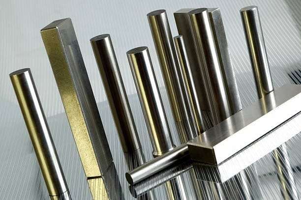 Set of titanium and steel cylindrical and rectangular bars used to illustrate differences in hardness and structure