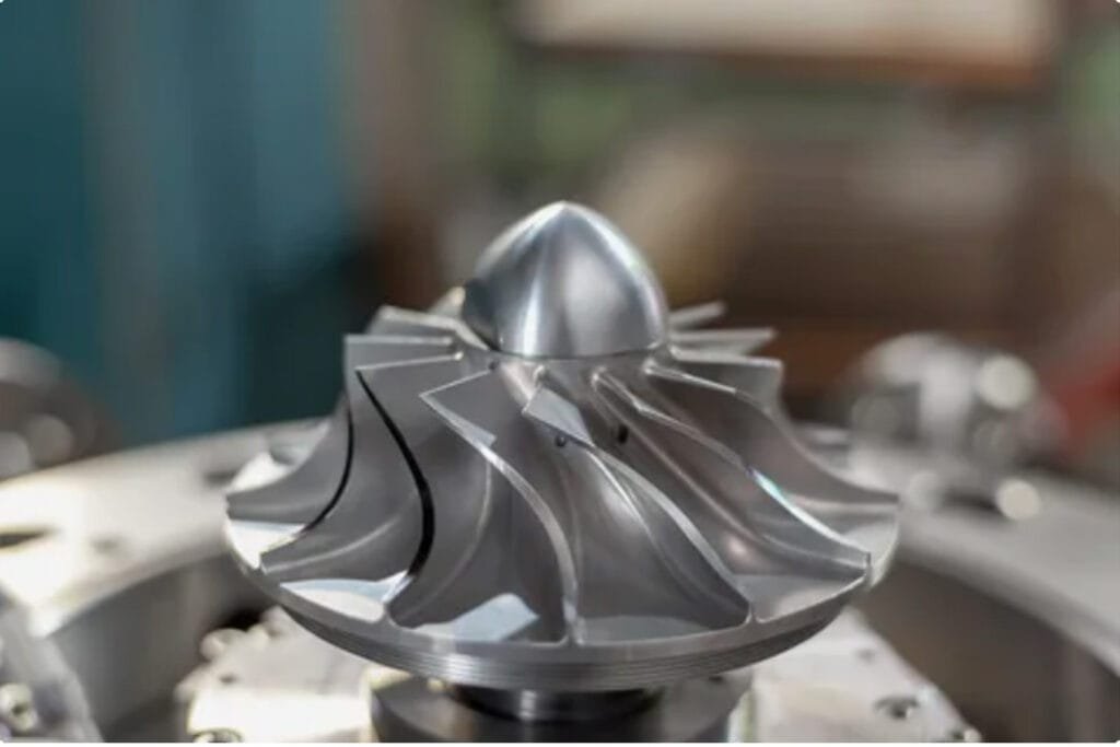 CNC-machined metal impeller turbine wheel with finely milled aerodynamic blades