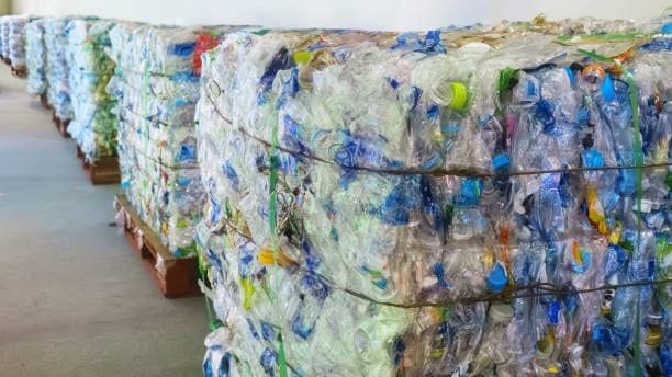 Stacks of compressed plastic bottles ready for recycling or remolding