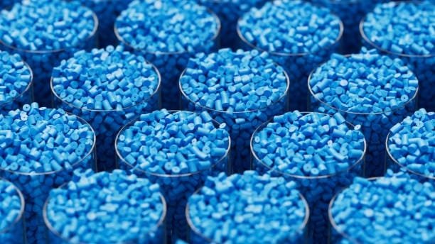 Multiple transparent containers filled with light blue plastic granules