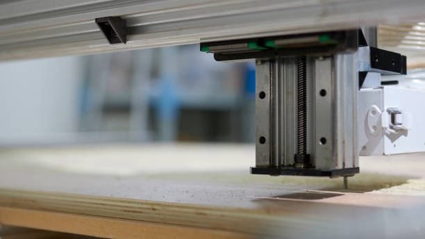 Close-up of CNC router z-axis setup above a DIY vacuum table platform