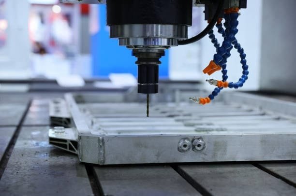 CNC spindle positioned above a vacuum fixture base for automated routing