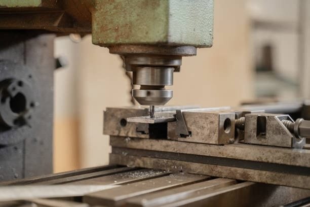 Swiss-type CNC machine turning a precision brass part with simultaneous tooling.
