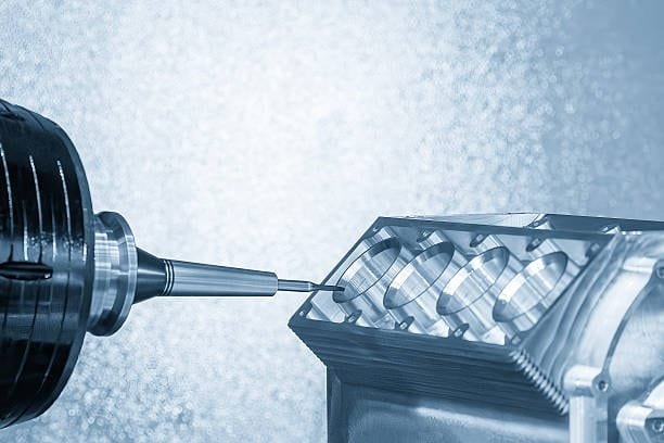 Engine block undergoing precision machining with a multi-axis drilling setup.