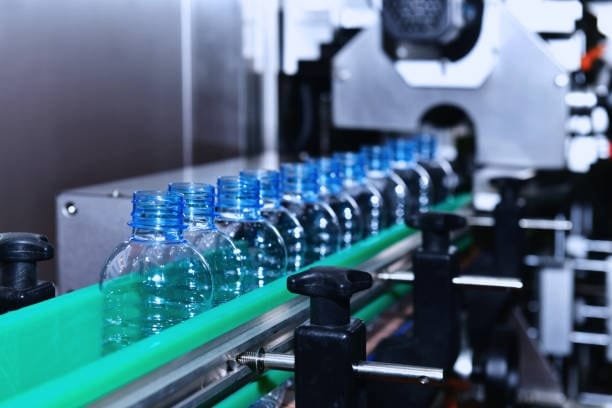 Plastic bottles moving on automated production line after molding process