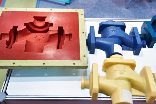 Mold and sample plastic castings showing part shape and cavity design