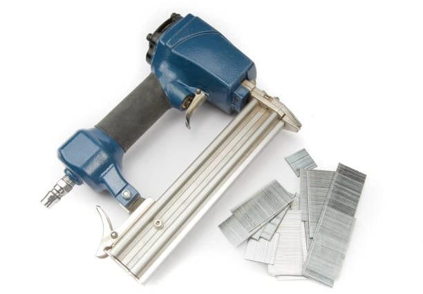 Pneumatic nail gun with collated nails used for CNC router workholding