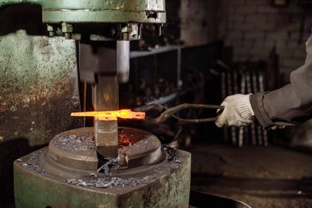 Compression press forging red-hot steel under high pressure