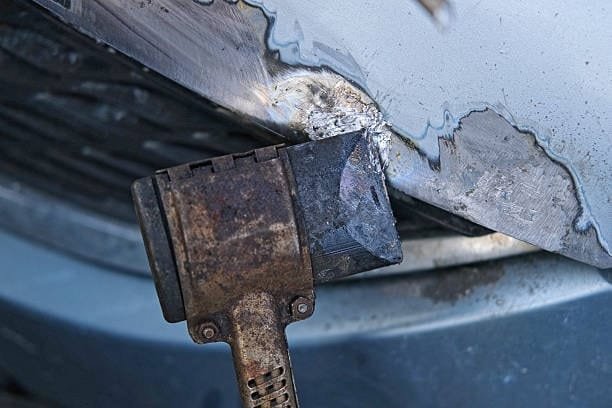Scraping tool removing oxidized and damaged metal surface on car body