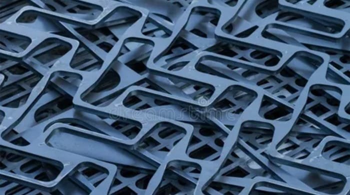 Stack of nested sheet metal parts featuring precise laser-cut profiles