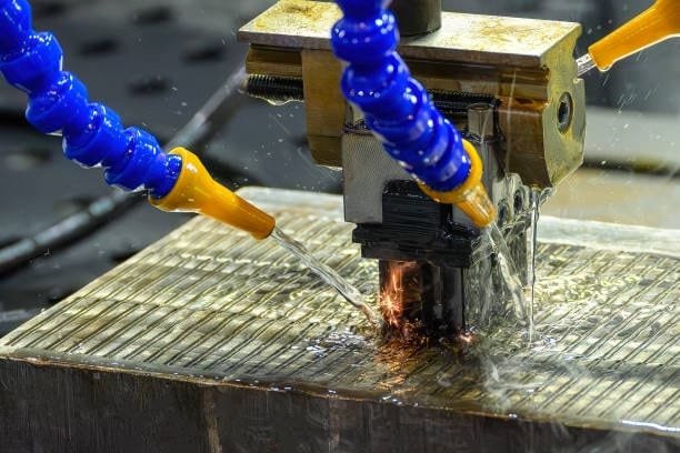 EDM machine performing spark discharge cutting on a metallic surface