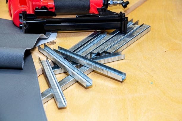 Close-up of stapler tool and metal staples for securing workpieces to CNC router beds