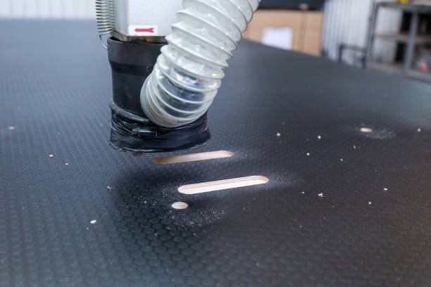Close-up of vacuum slot channels on CNC table to optimize air suction