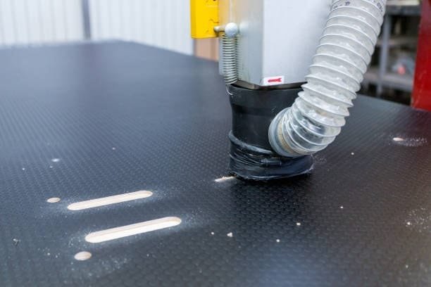 Vacuum suction in action on CNC table during machining with visible slots